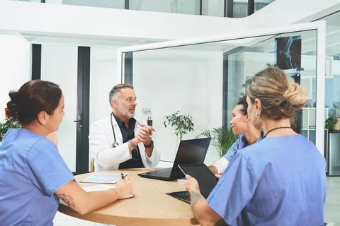 Lets continue to save as many lives as we can. a team of doctors having a Stock Photos