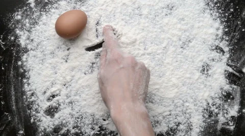 "Let's cook" written on black board with flour Video stock 60668141