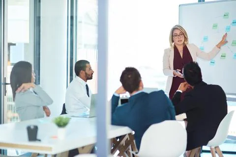 Lets discuss how we can improve this. corporate businesspeople having a meeting Stock Photos