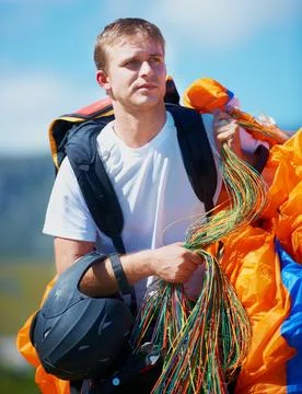 Lets do this. a man carrying his paragliding equipment. 스톡 사진