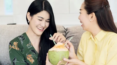 Let's drink this coconut tohether. Stock Footage 104070004