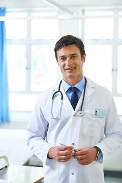 Lets find out what the problem is. Portrait of a handsome young doctor standing Stock Photos