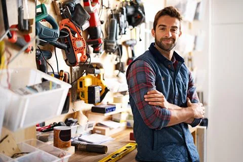 Lets fix it. Portrait of a handsome young handyman standing in front of his work Foto stock