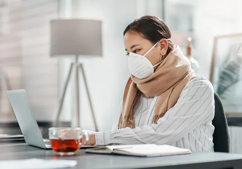 Lets get business bouncing back again. a masked young businesswoman using a Stock Photos