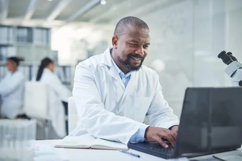 Lets get discovering. a confident scientist using a laptop to conduct research Stock Photos