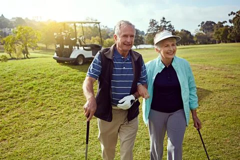 Lets get going. a smiling senior couple enjoying a day on the golf course. Fotos Stock