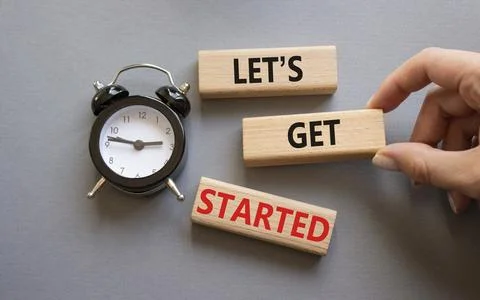 Lets get started symbol. Concept words Lets get started on wooden blocks. B.. Stock Photos