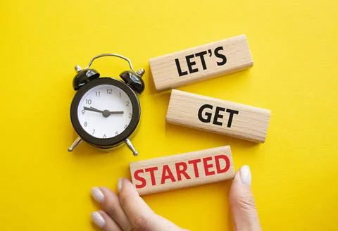 Lets get started symbol. Concept words Lets get started on wooden blocks. B.. Stock Photos