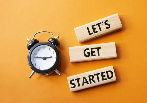 Lets get started symbol. Concept words Lets get started on wooden blocks. B.. Stock Photos