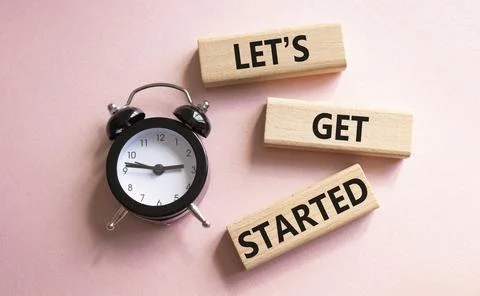 Lets get started symbol. Concept words Lets get started on wooden blocks. B.. Stock Photos