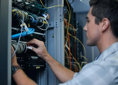 Lets get technical. Cropped shot of a handsome young male programmer working  写真素材