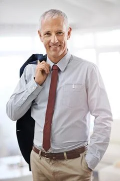 Lets get the work day started. Portrait of a mature businessman with his jacket Stock Photos
