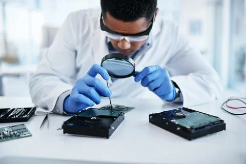 Lets get you back up and running again. a young man using a screwdriver and Stock Photos