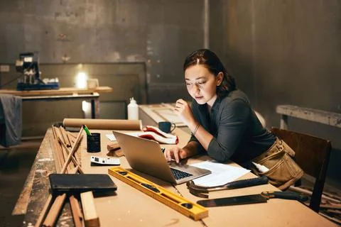 Lets go look at a few examples. an attractive young female carpenter working on Stock Photos