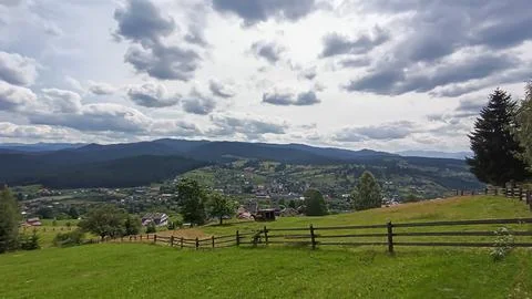 Let's go up the mountain. Landscape with clouds, pine trees and green grass.  Fotos de archivo