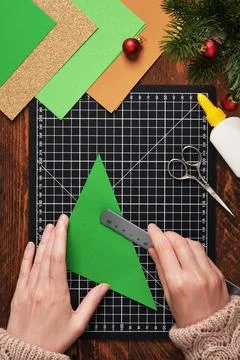 Let's make a simple paper craft. A bookmark in the shape of a Christmas tre.. Stock Photos