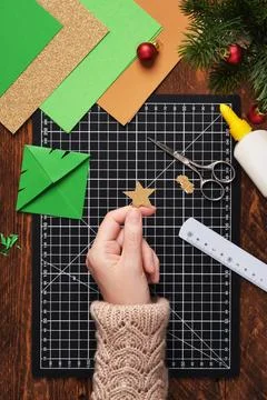 Let's make a simple paper craft. A Christmas tree bookmark. Cut out a star .. Stock Photos