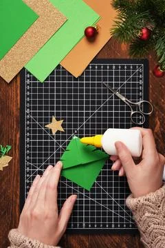 Let's make a simple paper craft. A bookmark in the shape of a Christmas tre.. Stock Photos