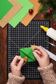 Let's make a simple paper craft. A bookmark in the shape of a Christmas tre.. Stock Photos