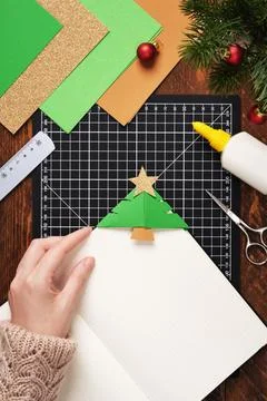 Let's make a simple paper craft. A bookmark in the shape of a Christmas tre.. Stock Photos