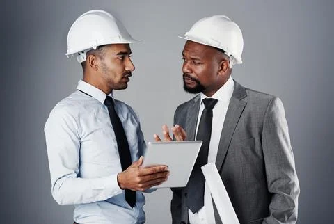 Lets make these plans a reality. two civil engineers discussing building plans Fotos de archivo