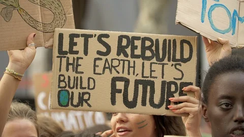 Lets rebuild the earth lets build our future. Girls and Posters at Global Strike Stock Footage 116796481