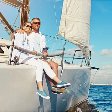 Lets stick together as long as we love and travel. a couple enjoying a boat Fotos Stock