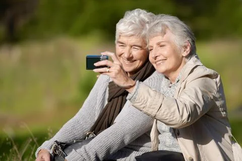 Lets take one more...Two senior women using a digital camera with a smile. 스톡 사진