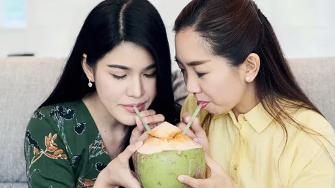 Let's try this coconut juice. Stock Footage 104070090