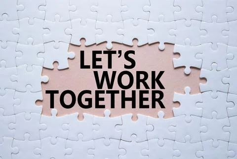 Lets work together symbol. Concept words Lets work together on white puzzle.. Stockfoto's
