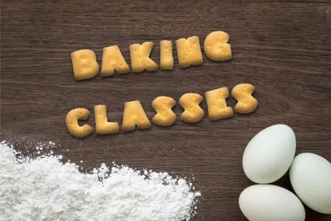 Letter biscuits word BAKING CLASSES  on kitchen table background Stock Photos