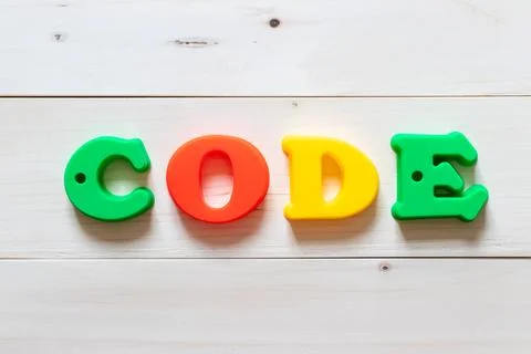 Letter block in word code on white wood background Photos