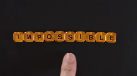 Letter Blocks Spell Impossible and Possible Stock Footage 46634174