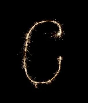 Letter C drew with spakrs on a black background. Stock Photos