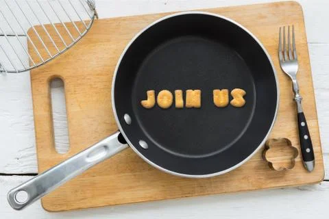 Letter cookies word JOIN US and kitchen utensils Stock Photos