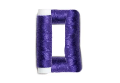 Letter of D from thread spools, isolated on white background. Alphabet concep Stock Photos