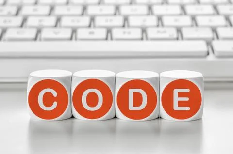 Letter dice in front of a keyboard - Code Stockfoto's