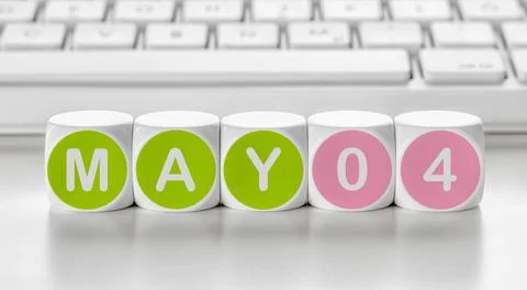 Letter dice in front of a keyboard - May 04 Photos