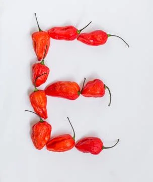 Letter E alphabet made with Ghost pepper Bhoot jolokia over white background Stock Photos