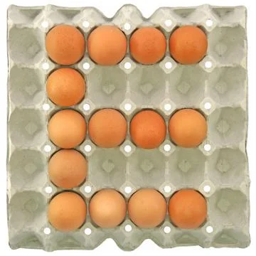 A letter E from the eggs in paper tray Stock Photos