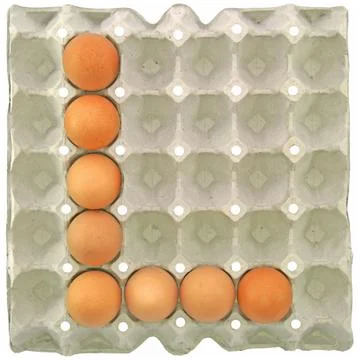 A letter E from the eggs in paper tray Stock Photos