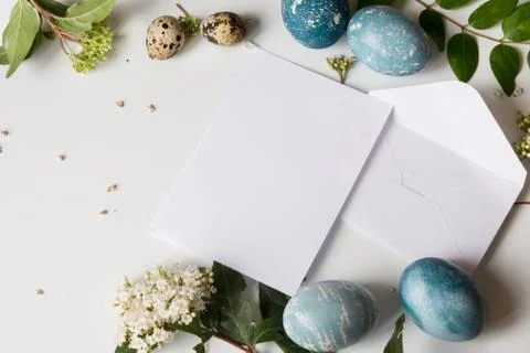 Letter empty Easter decorated eggs and fresh white flowers Stock Photos