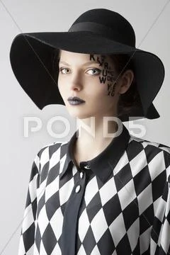 The letter on the face creative makeup girl, she looks in to the lens Stock Photos