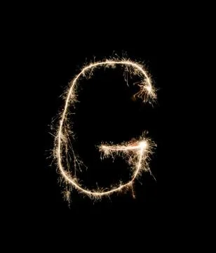 Letter G drew with spakrs on a black background. Foto stock