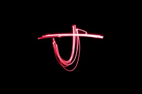 Letter J written with light paint photography technique on black background.  Stock Illustration