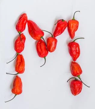 Letter M alphabet made with Ghost pepper Bhoot jolokia over white background Stock Photos