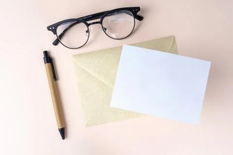 Letter mock up template, envelope with a white blank card, pen and glasses Stock Photos