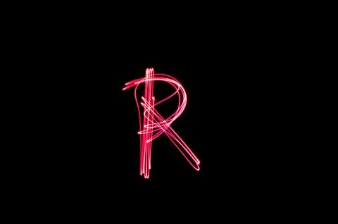 Letter R written with light paint photography technique on black background.  Stock Illustration