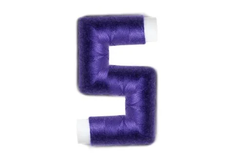 Letter of S from thread spools, isolated on white background. Alphabet concep Stock Photos