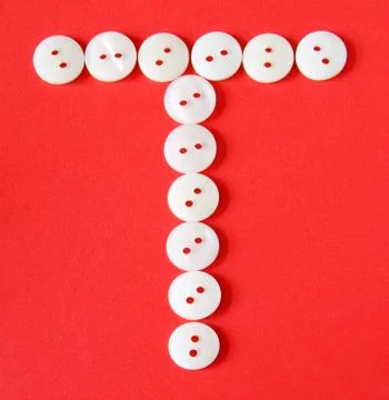 Letter "t" from buttons on a red background 库存插图